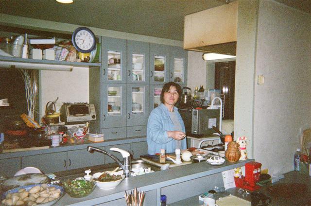 Sumiko in the kitchen making breakfast.